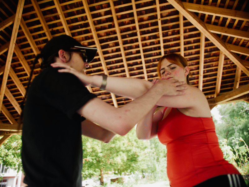 A photo of two Uncurbed performers performing 'Shared Spaces', presented in Whitworth Park